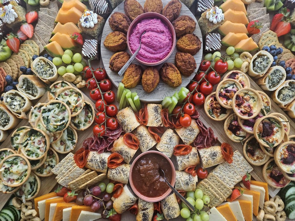 An image of a grazing table showing a range of savoury and sweet foods